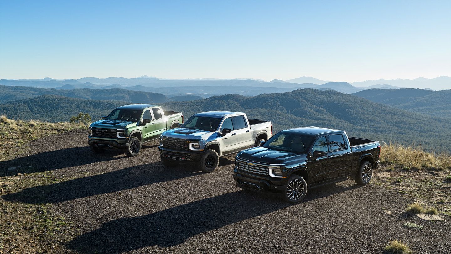 2027 Chevrolet Silverado - three 2027 Chevrolet Silverado pickup trucks parked together at a scenic mountain overlook - Humberview Group - New car dealerships in Ontario