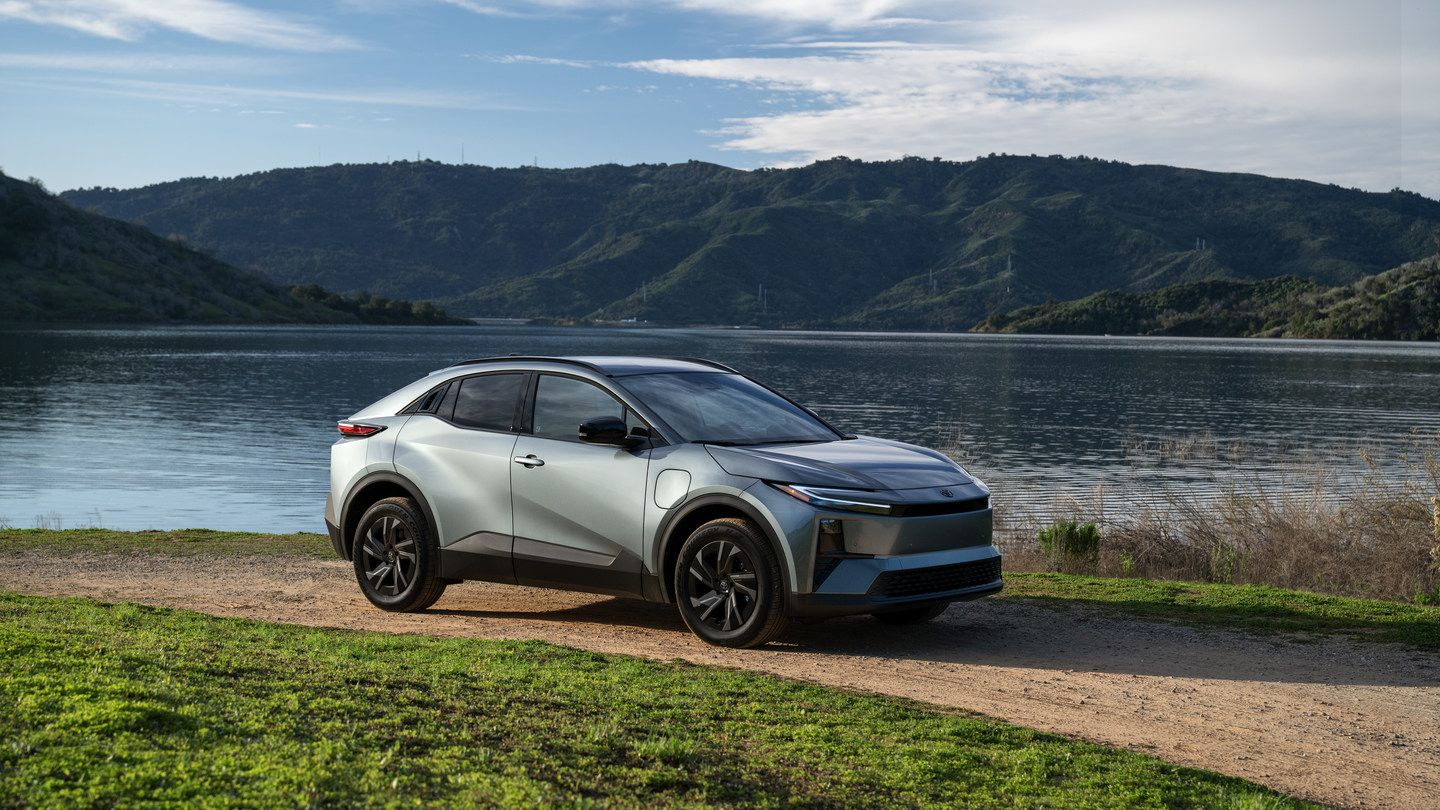 2027 Toyota C-HR - front three-quarter view of a silver 2027 Toyota C-HR parked along a dirt path overlooking a scenic lake - Orangeville Toyota - Toyota new car dealership in Orangeville, Ontario