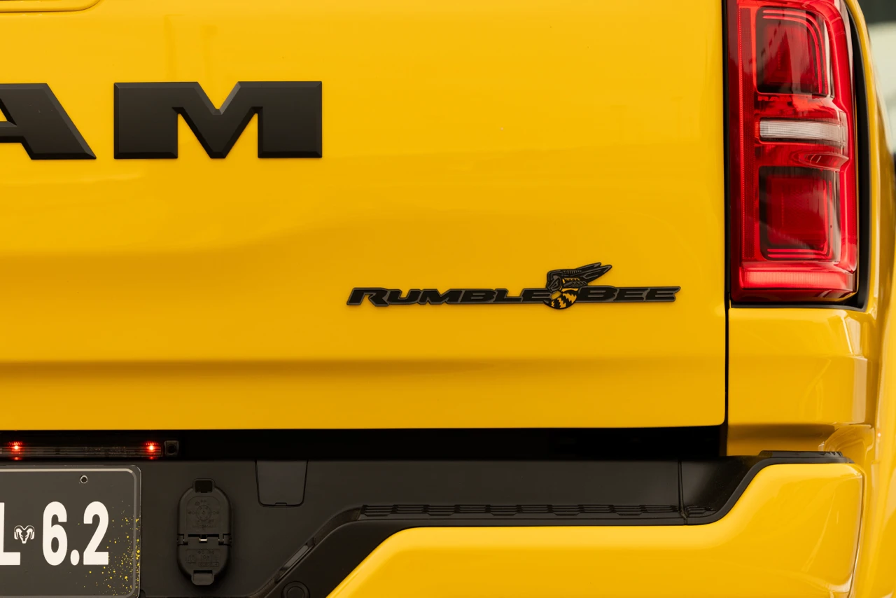 Rumble Bee badge on the yellow tailgate of the 2027 Ram 1500, beside the rear taillight.