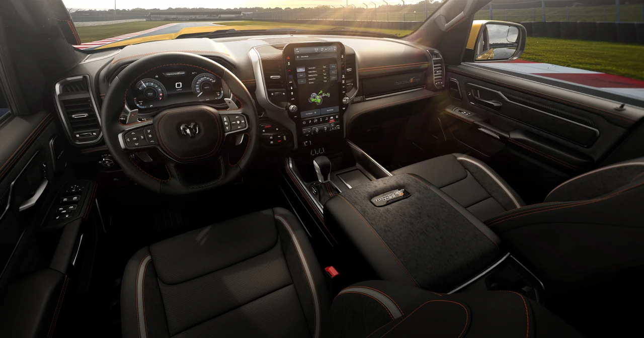 2027 Ram 1500 Rumble Bee cabin with black front seats, a multifunction steering wheel and a large central touchscreen.
