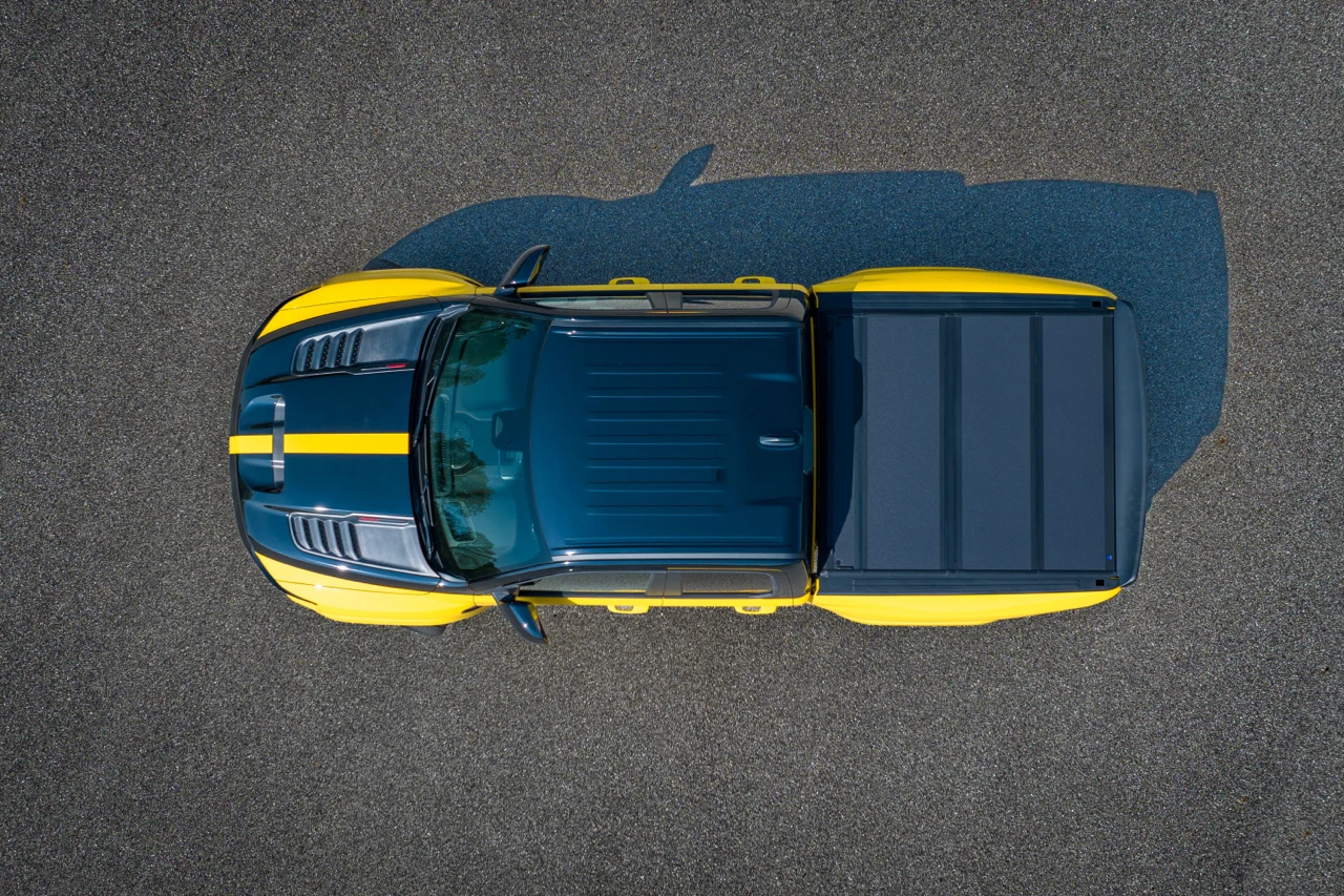 Overhead view of the yellow 2027 Ram 1500 Rumble Bee showing its black hood accents, cab and covered bed.