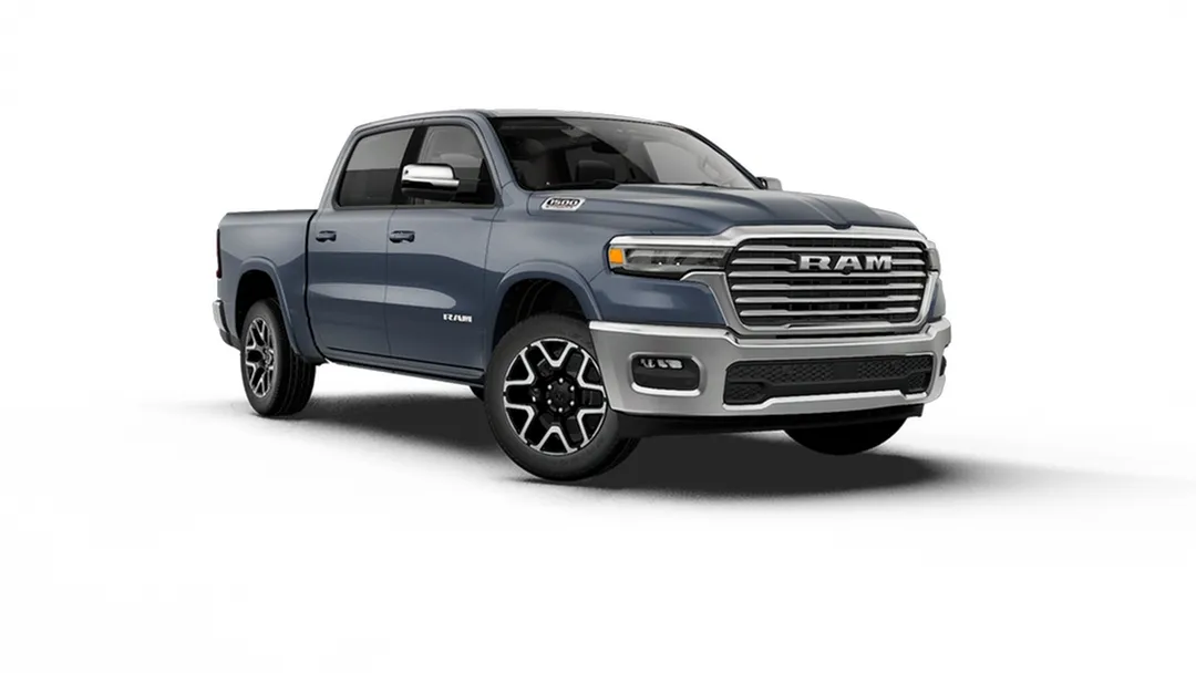 Grey Ram 1500 Laramie with a chrome grille and alloy wheels, shown from the front three-quarter angle.