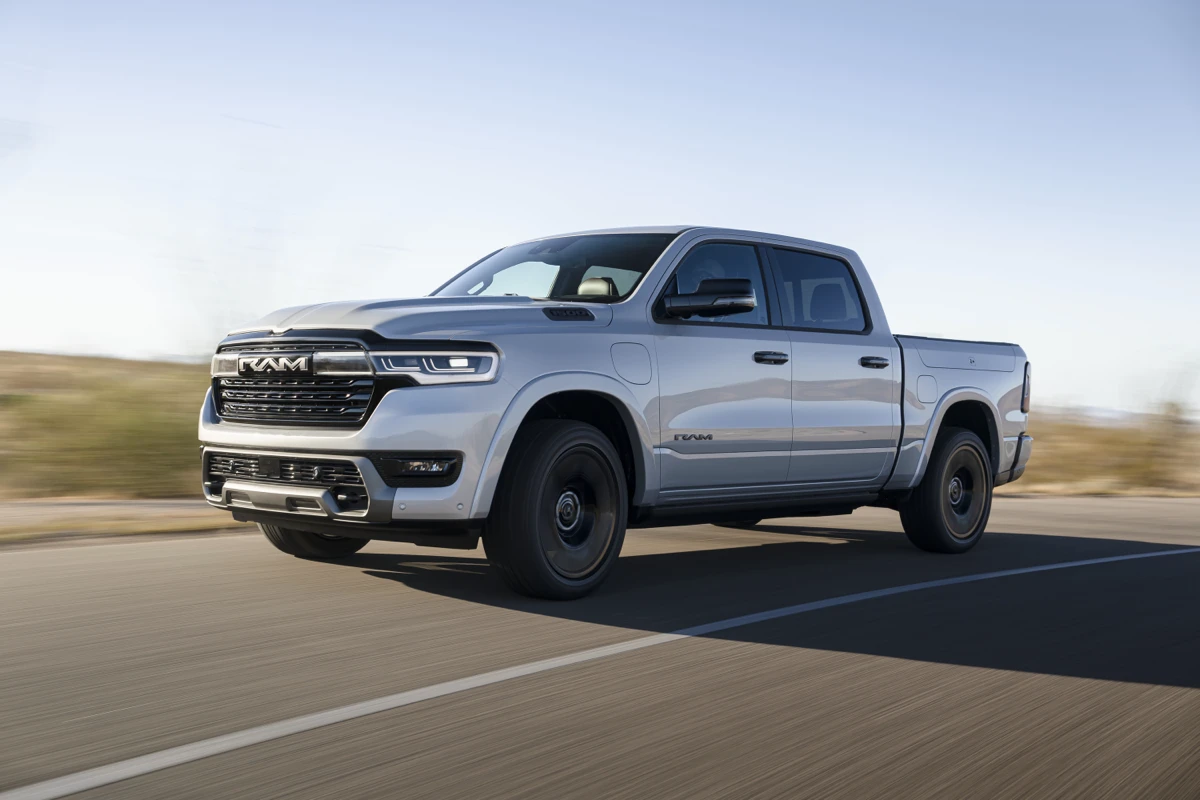 White Ram 1500 REV driving on a paved road, shown from the front three-quarter angle.