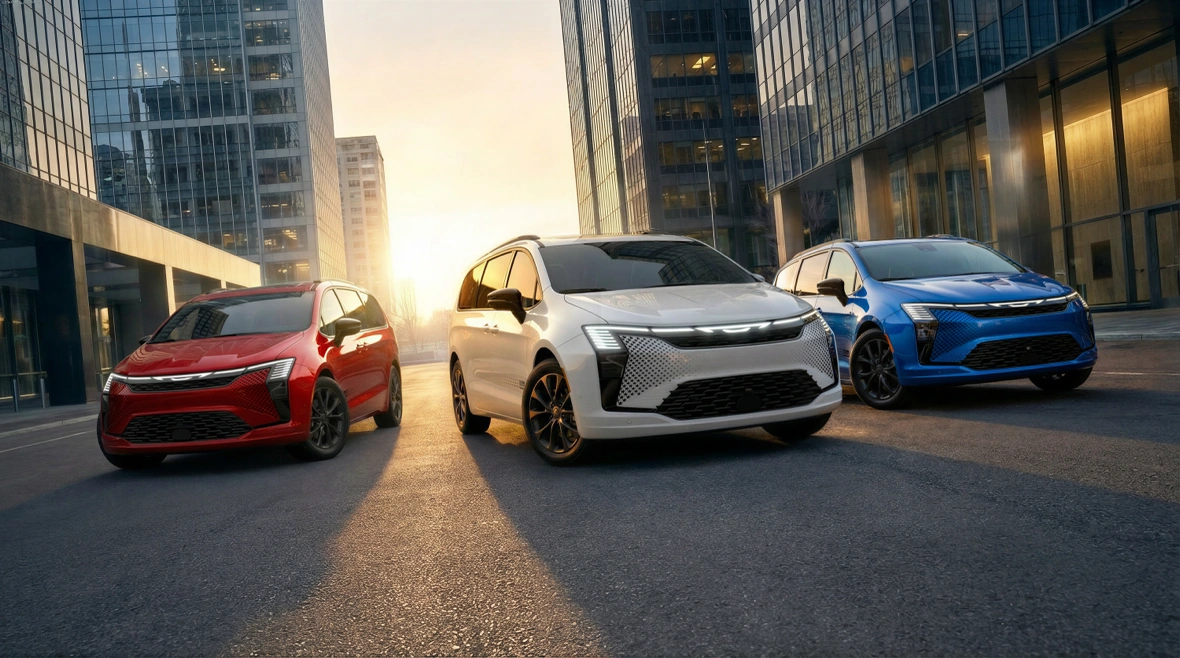 Red, white and blue 2027 Chrysler Pacifica minivans showcasing exterior colours on a city street.
