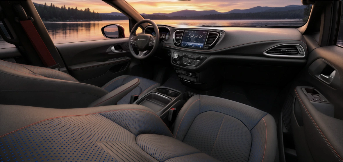 Chrysler Pacifica front cabin with a central Uconnect touchscreen, steering wheel and centre console.