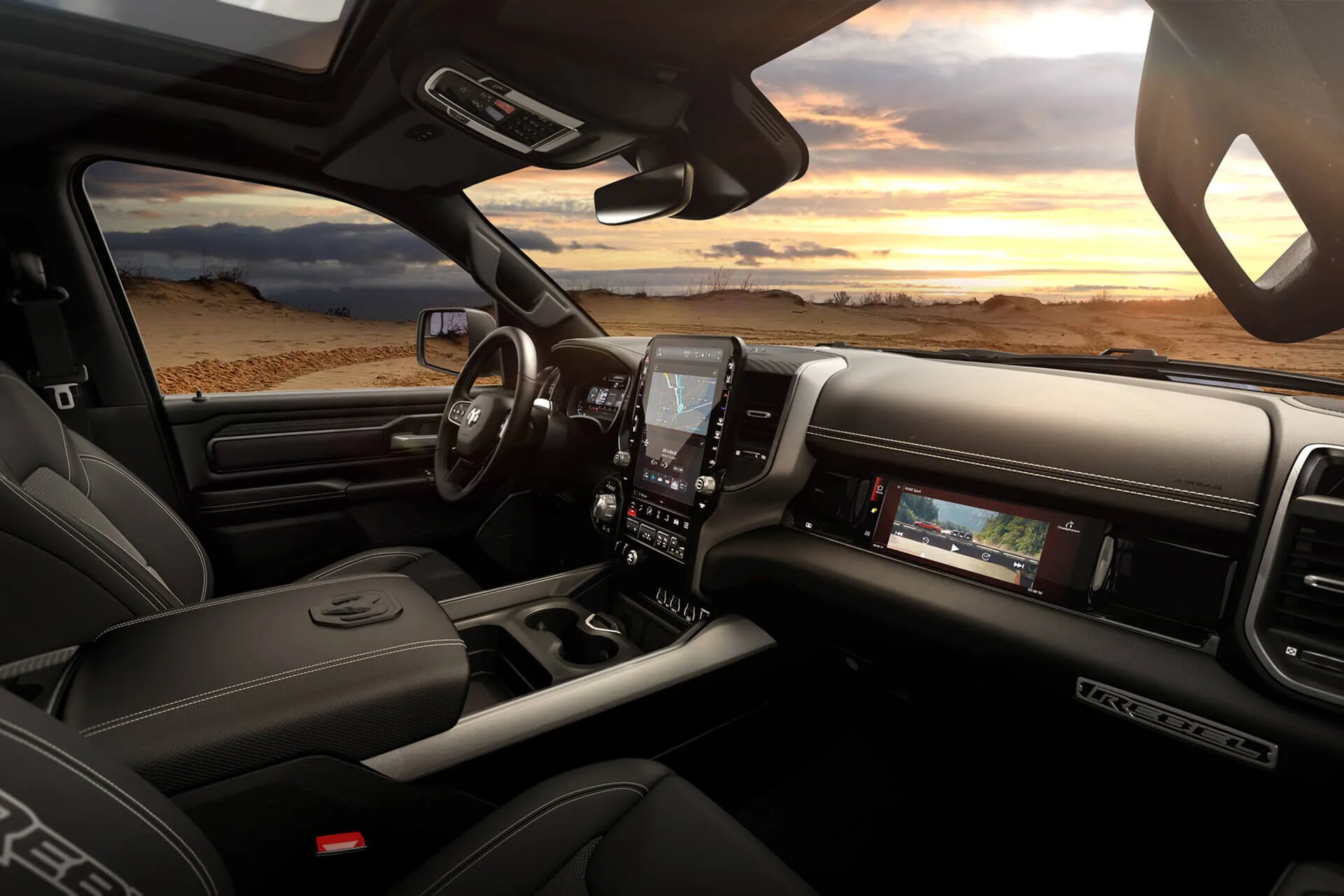Ram 1500 interior with a vertical Uconnect touchscreen, front-passenger display and panoramic sunroof.