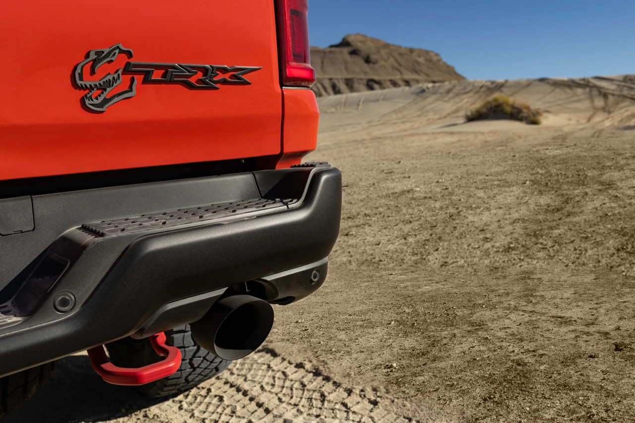 Close-up of the red Ram 1500 SRT TRX tailgate badge, rear bumper, tow hook and exhaust outlet.