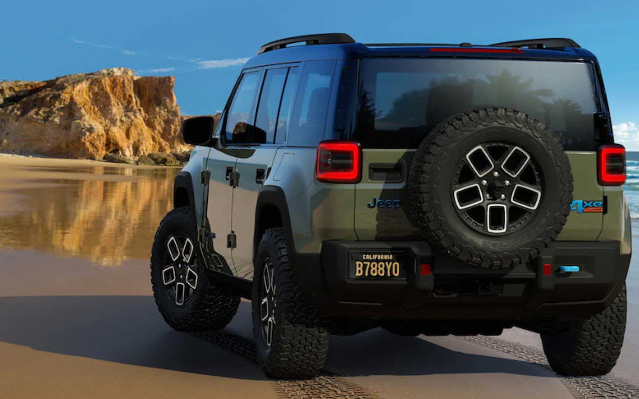 rear side view of a 2024 Jeep Recon on a beach
