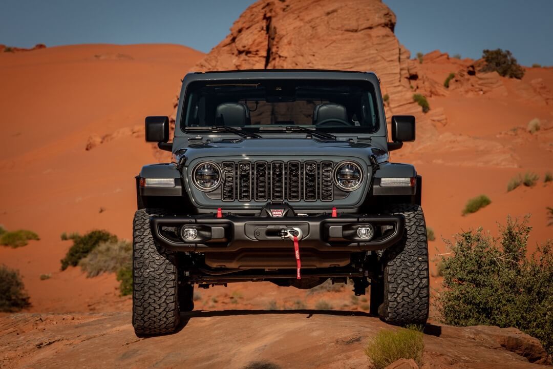 Front view of 2024 Jeep Wrangler parked in a desert.