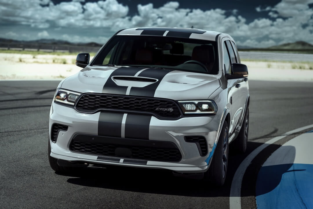 Gray Dodge Durango parked on a racetrack curve.