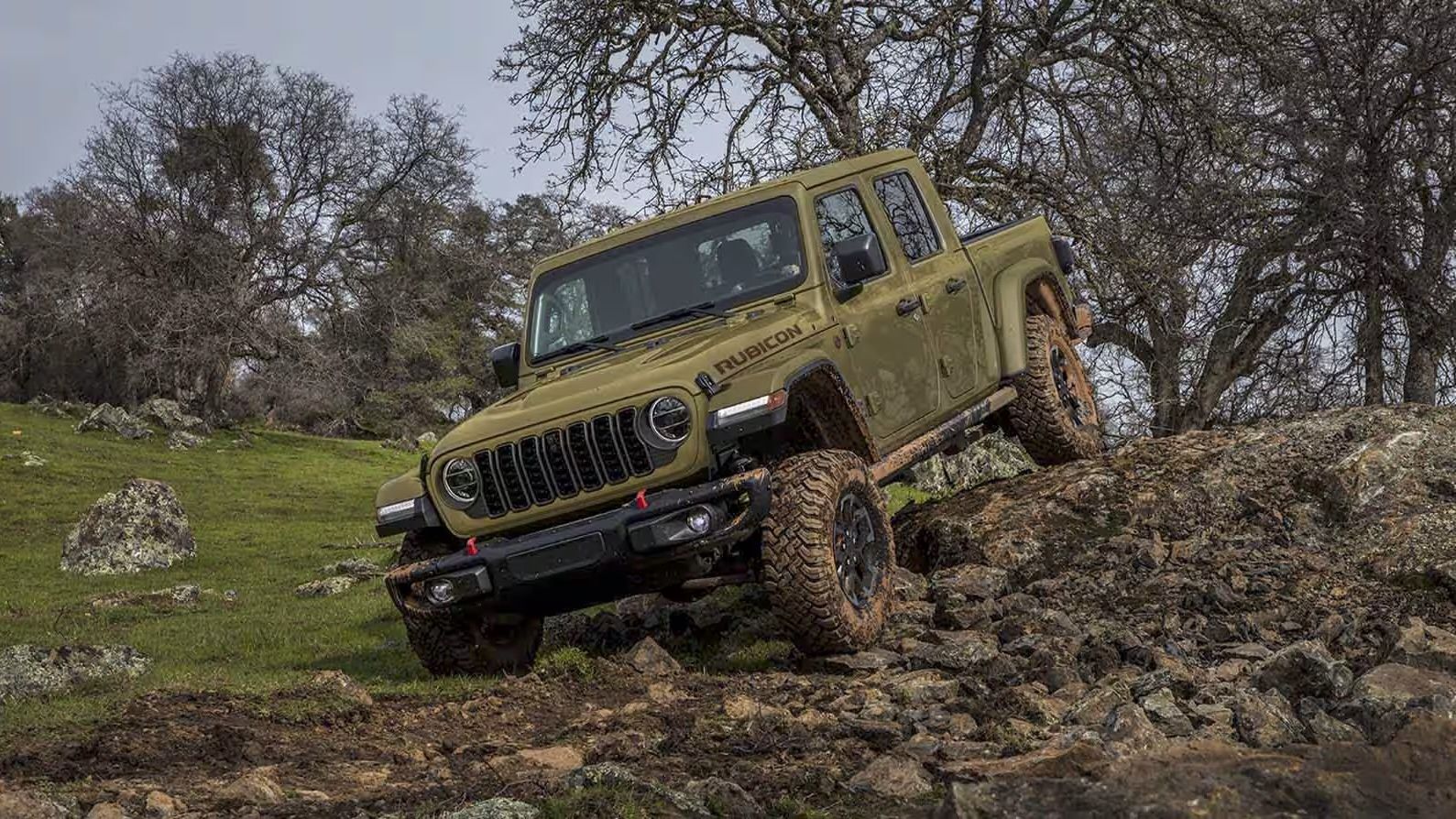 The 2025 Jeep Gladiator rolling over big rocks.