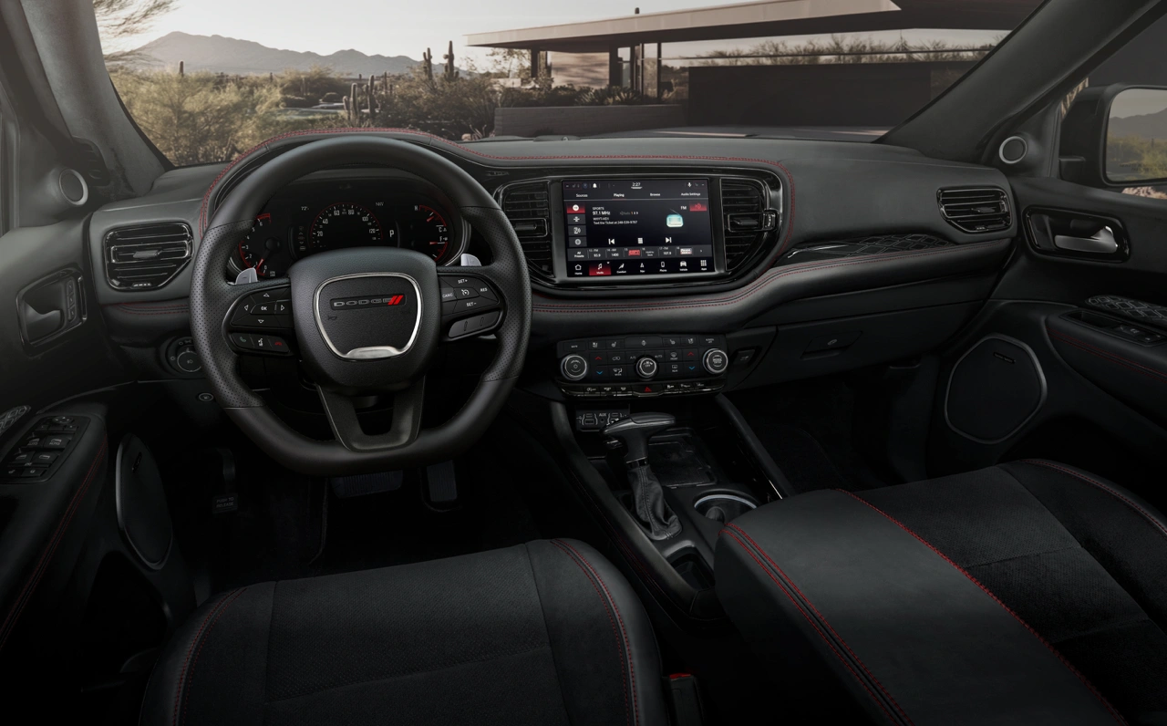 2026 Dodge Durango interior featuring modern dashboard, central touchscreen display and sport steering wheel.