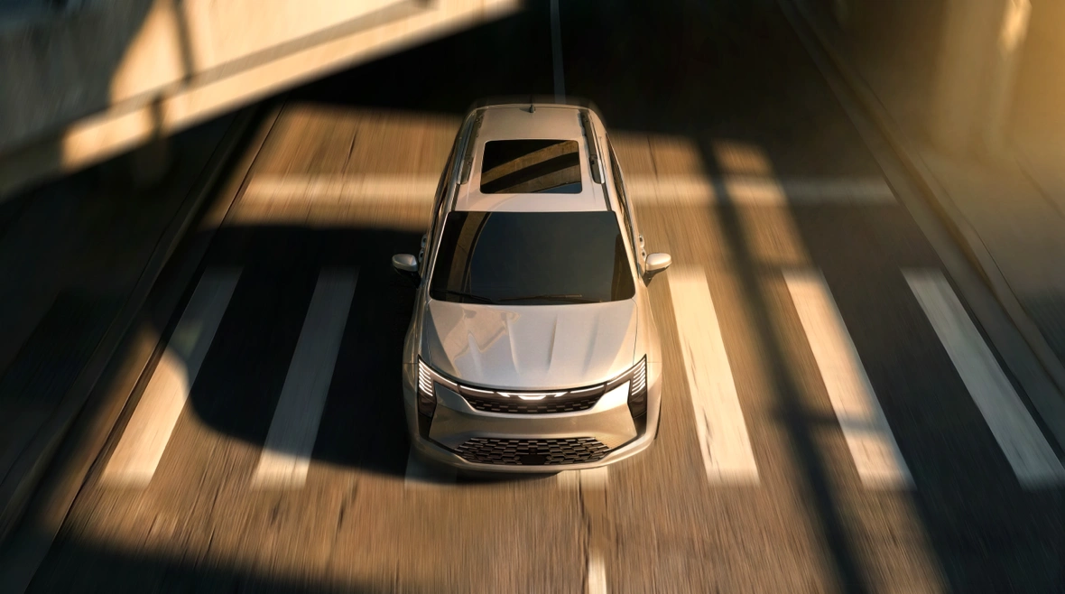 Aerial view of a white 2027 Chrysler Pacifica in motion.
