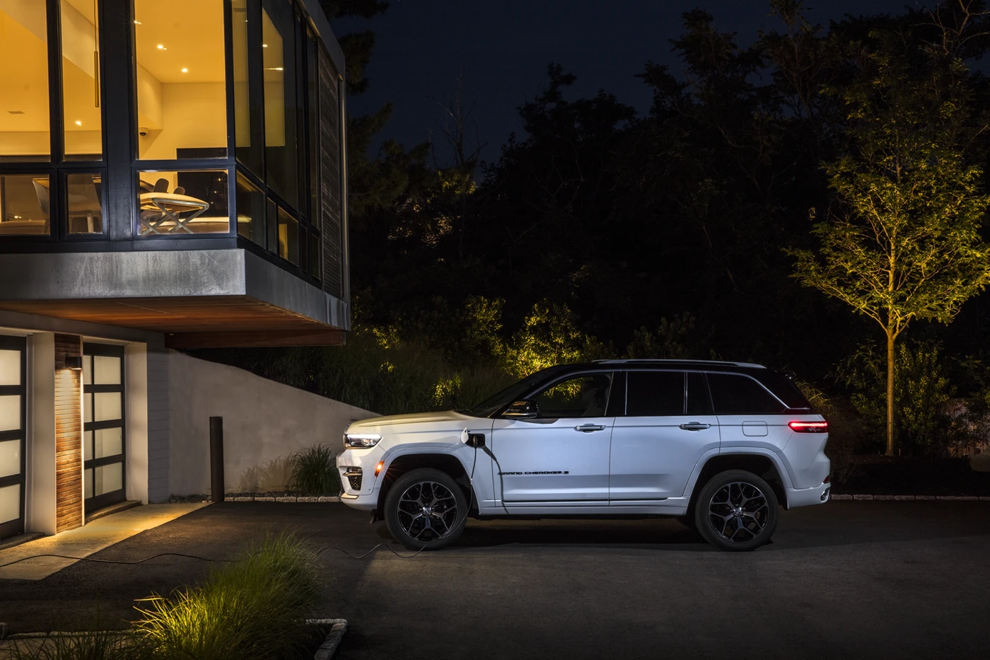 2025 Jeep Grand Cherokee 4xe in front of a residence.