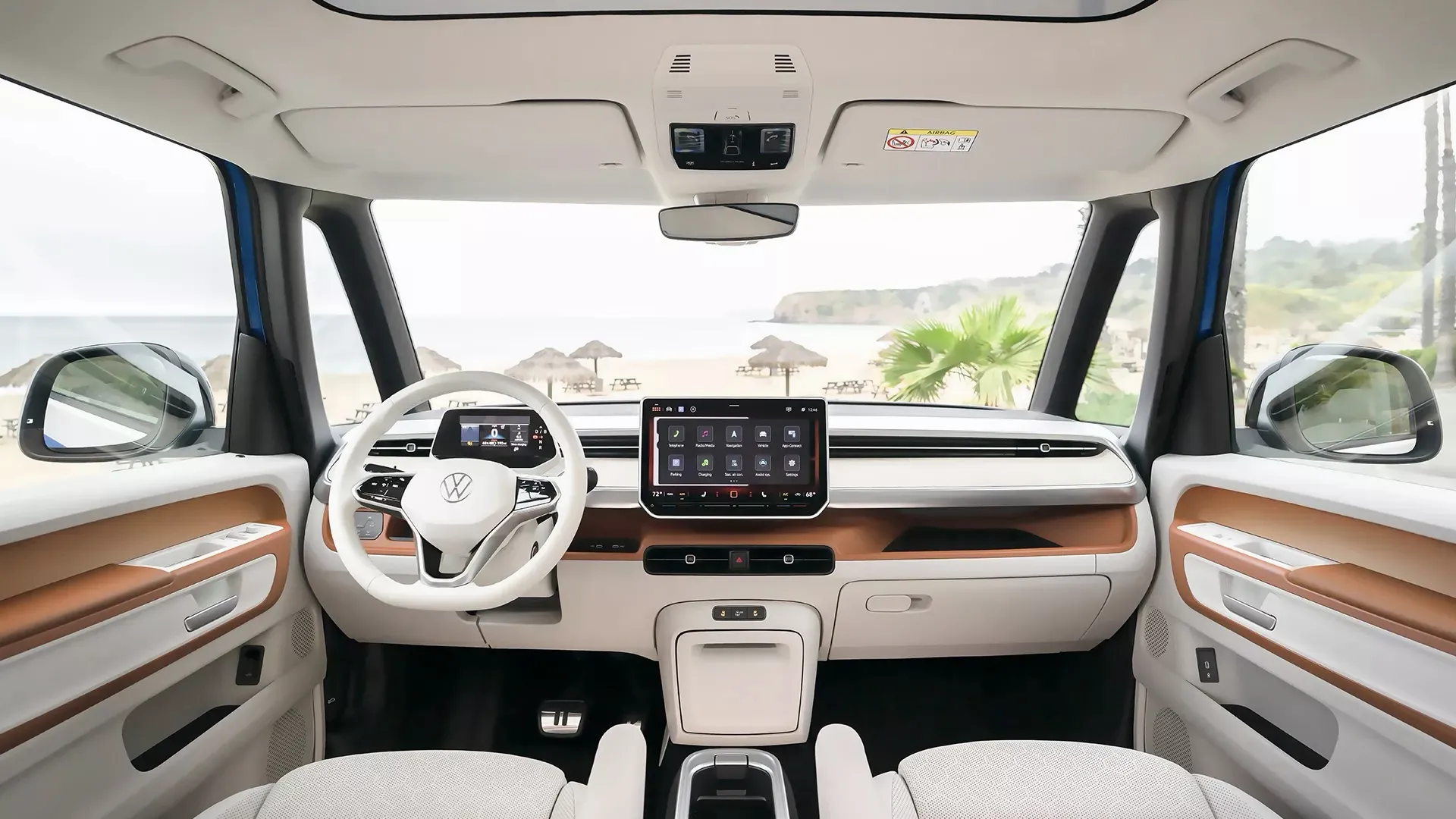 Dashboard and steering wheel of the Volkswagen ID. Buzz, with a beach view