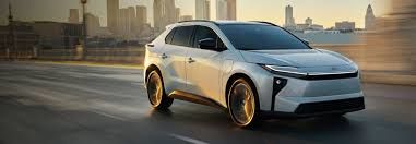 white BZ driving along a city street