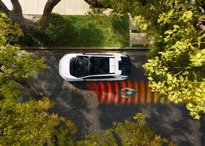 View from inside a car's driver's seat while driving through a tunnel at night, showing light trails.