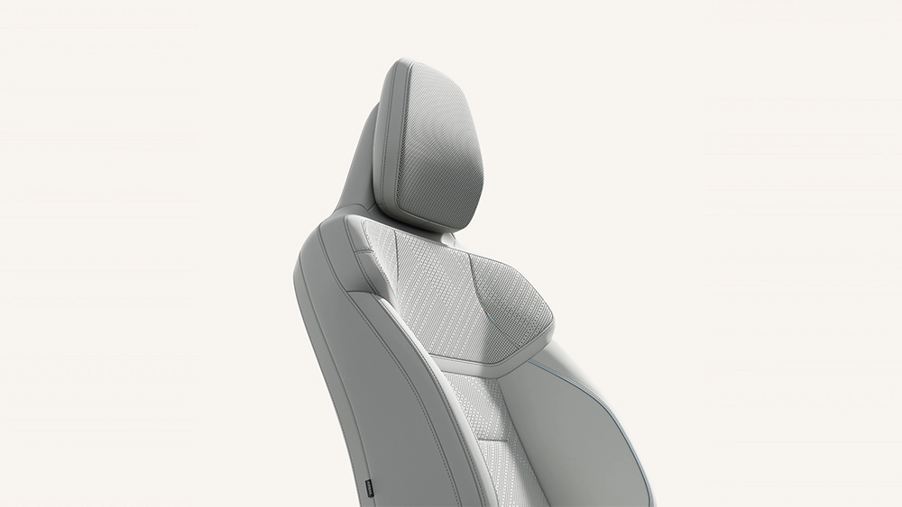 Isolated studio view of a Volvo ergonomic front car seat upholstered in light gray fabric and leather trim.