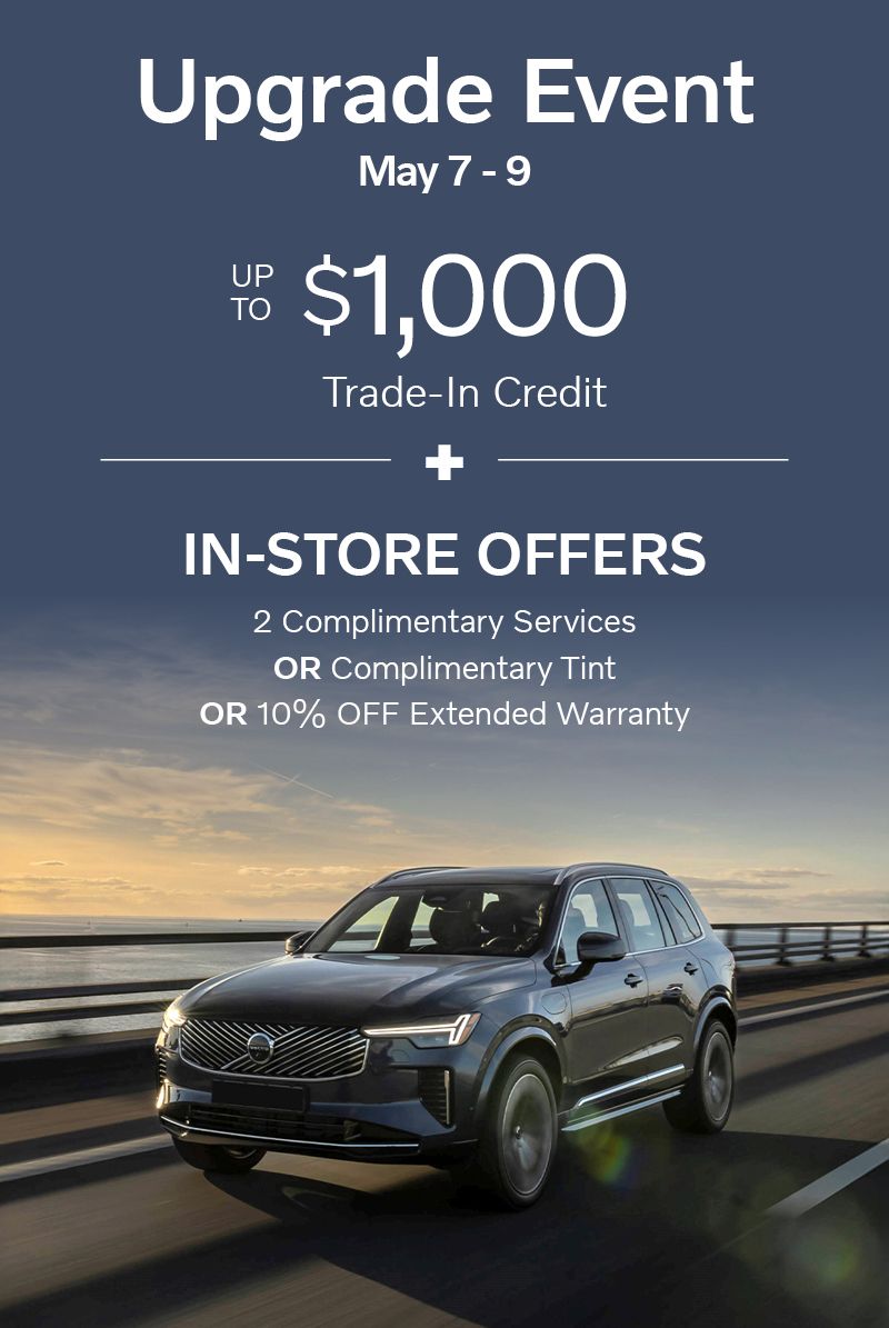 Upgrade Event automotive promotion banner featuring a luxury SUV driving on a coastal highway at sunset, with text “Upgrade Event May 7–9,” “up to $1,000 trade-in credit,” and “in-store offers” including 2 complimentary services, complimentary tint, or 10% off extended warranty, highlighting limited-time dealership incentives.