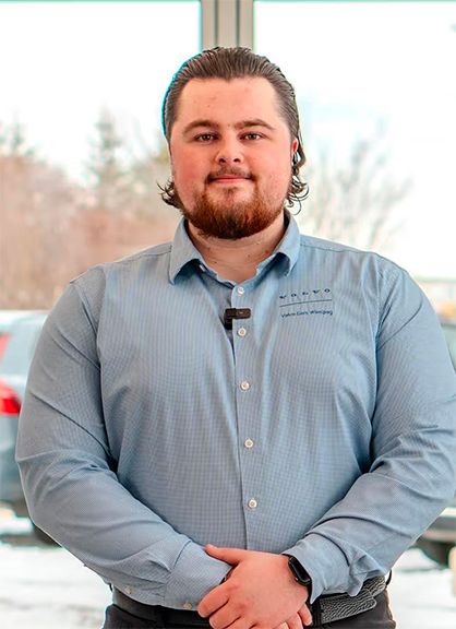 A man in a blue Volvo Cars Winnipeg button-down shirt.