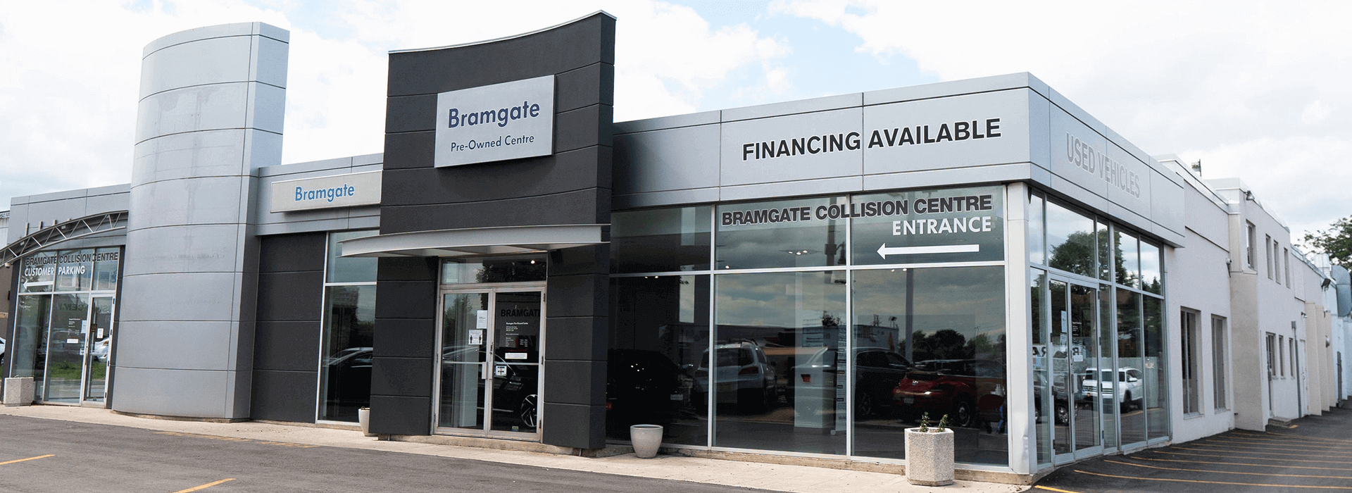 Exterior view of the Bramgate Pre-Owned Centre dealership and the entrance to the Bramgate Collision Centre, with signage indicating that financing is available.