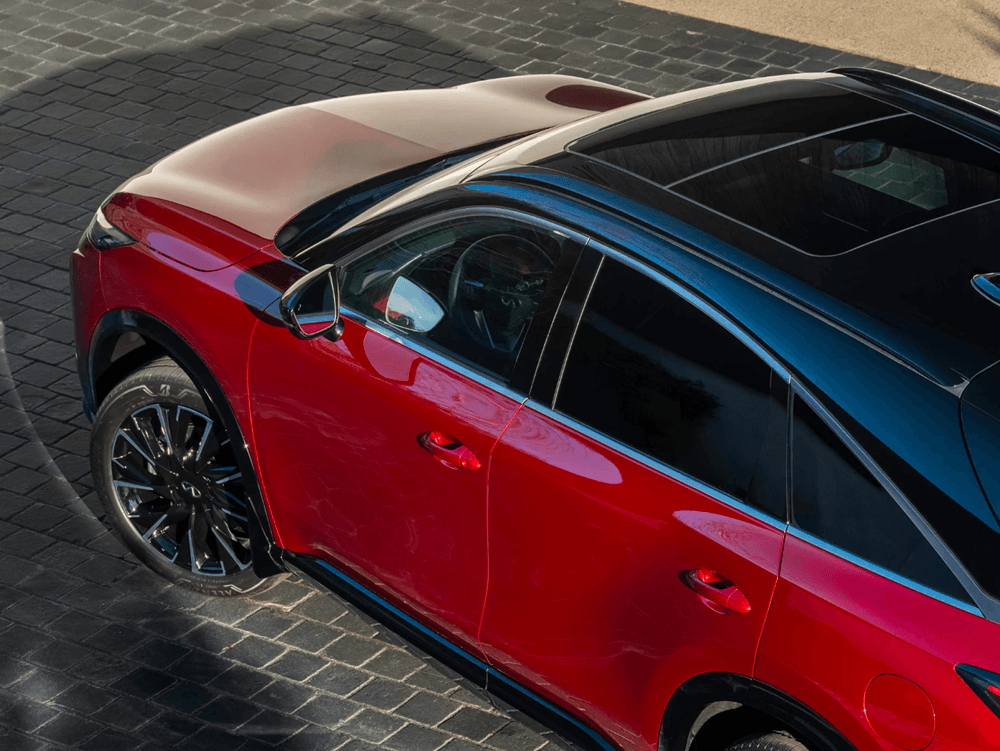 High-angle view of a red Infiniti QX65 with a black roof.