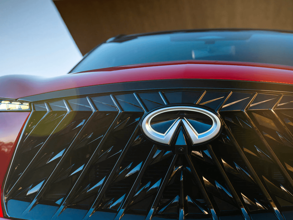 Detailed close-up of the front grille and emblem of an Infiniti QX65.