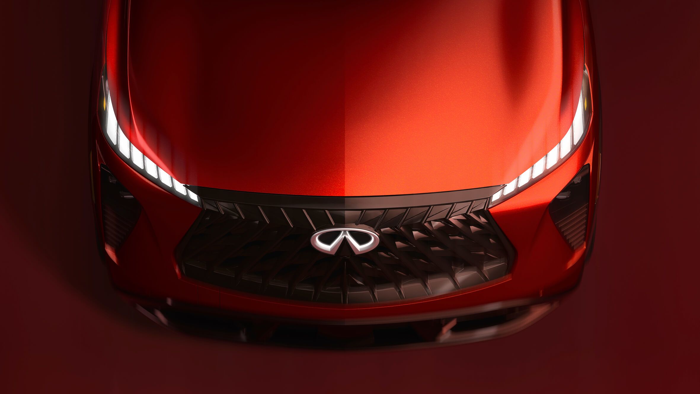 Front view of a red Infiniti SUV showing the grille and headlights.