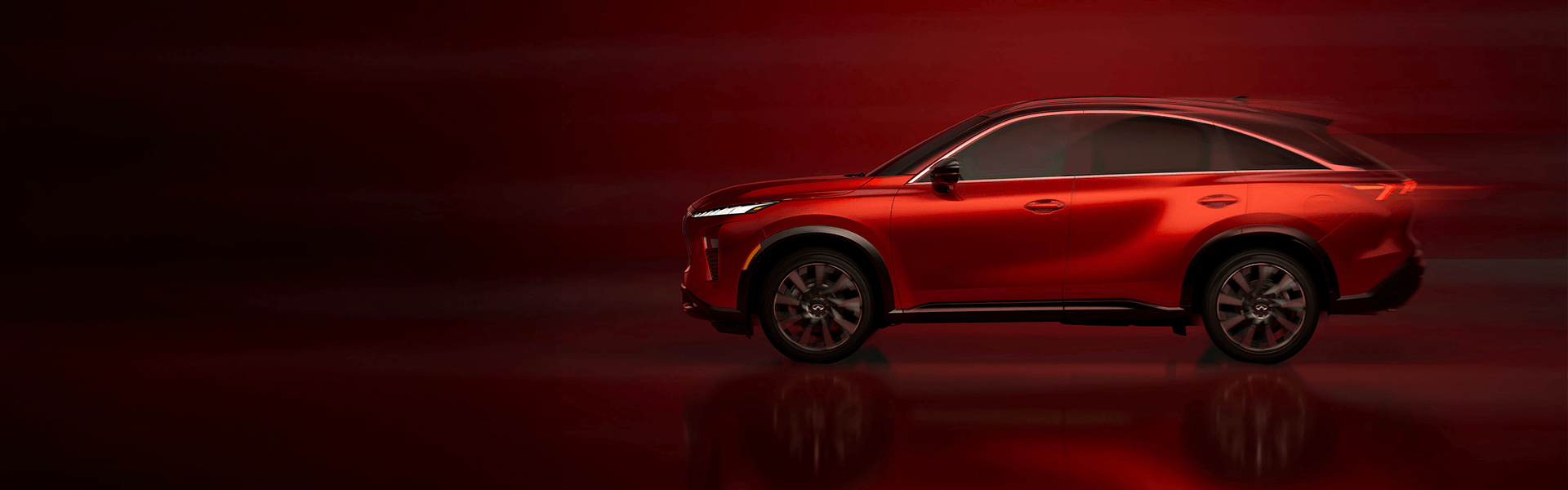 Side profile of a red Infiniti SUV.