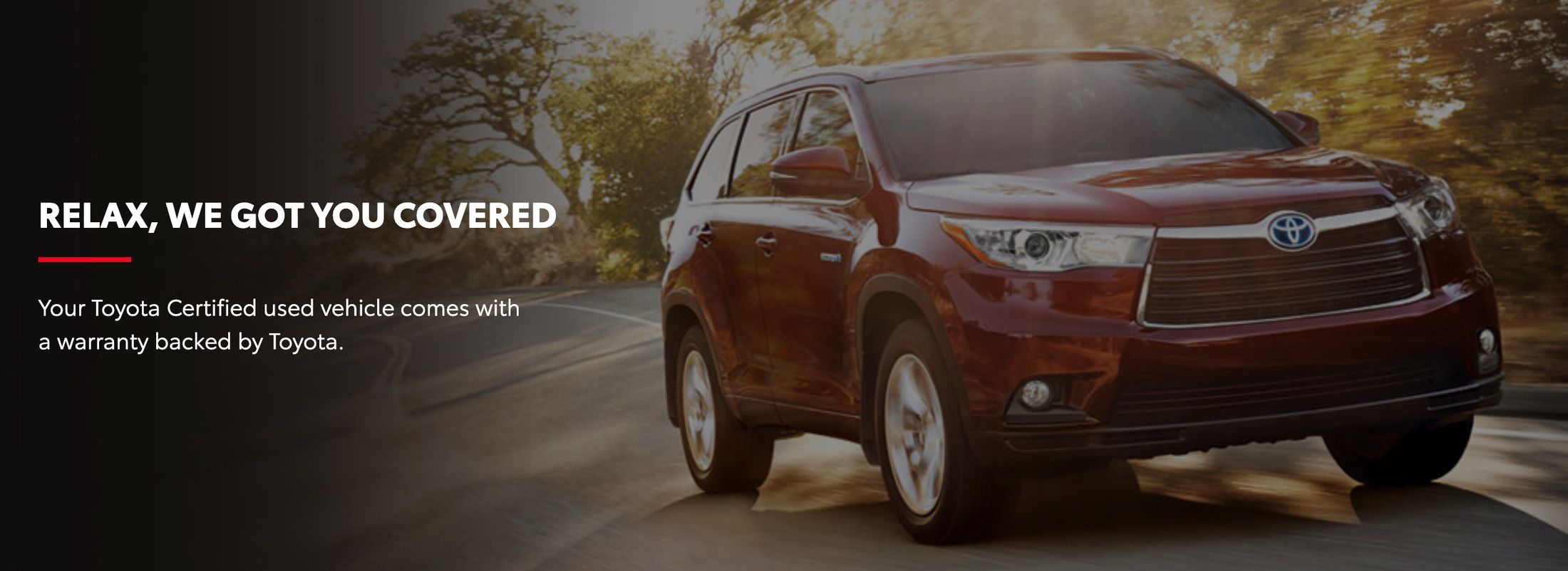 A red Toyota Highlander driving on a road next to promotional text about a Toyota Certified warranty: "RELAX, WE GOT YOU COVERED."
