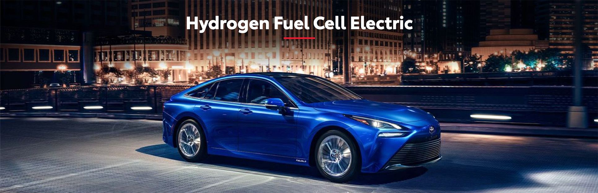  Blue Toyota Mirai hydrogen fuel cell car at night.
