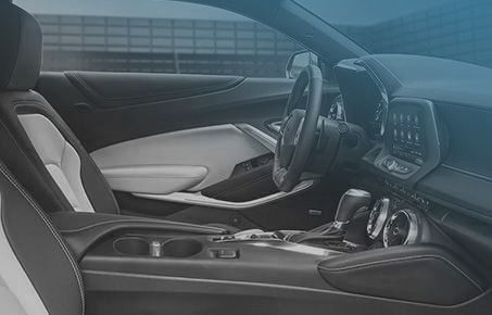 Interior view of a modern vehicle cockpit featuring the steering wheel and dashboard.