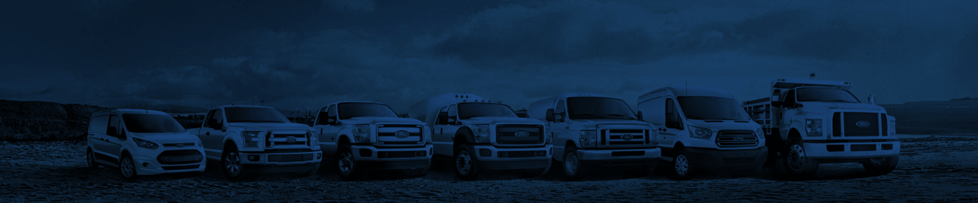 A wide panorama of the Ford commercial vehicle lineup, featuring vans and trucks from light-duty to heavy-duty, under a dark blue overlay.