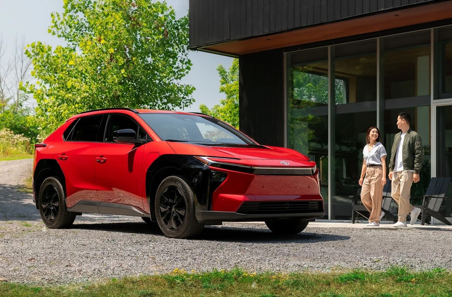 Overhead view of many cars in various colors, parked in three organized rows on a white background.
