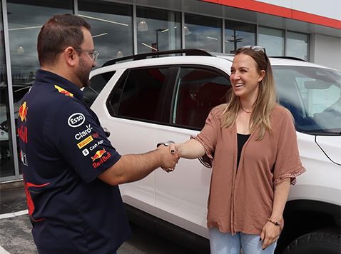 Manager is buying car off female seller.