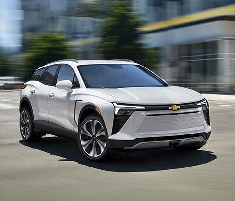 View from inside a car's driver's seat while driving through a tunnel at night, showing light trails.