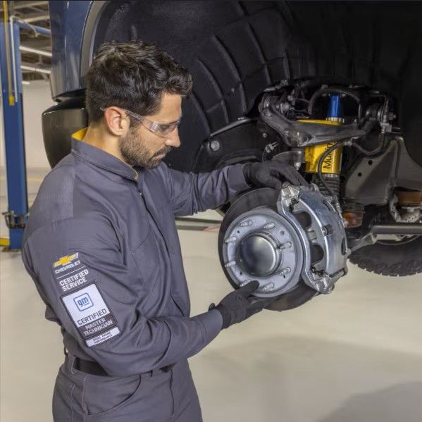 Overhead view of many cars in various colors, parked in three organized rows on a white background.
