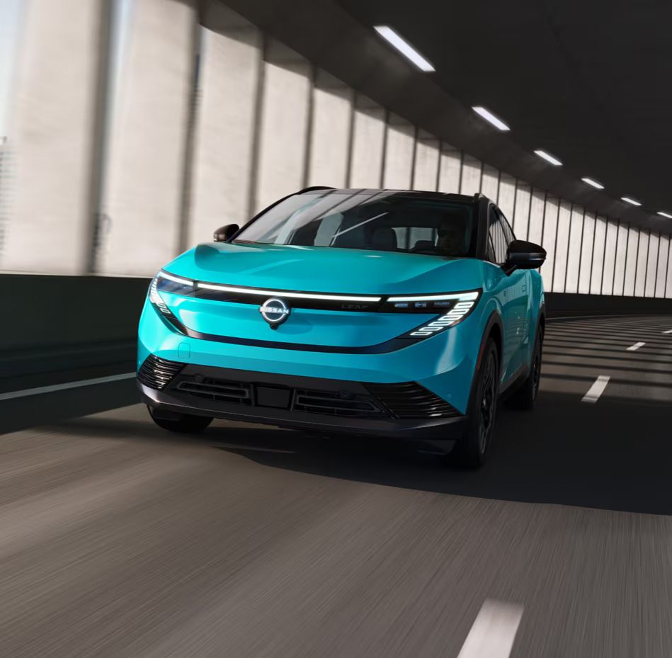 Teal blue compact SUV driving inside a tunnel.