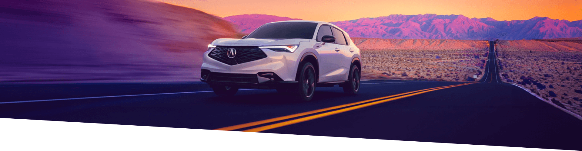 Un VUS Acura blanc circulant sur une autoroute de désert au coucher du soleil.