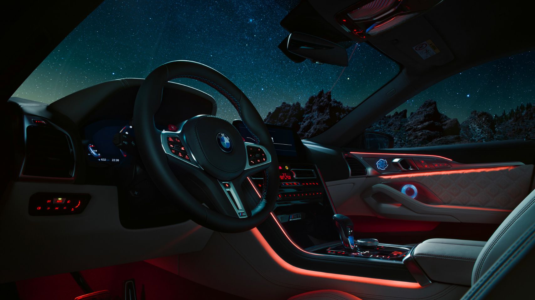Interior cockpit view of a BMW M8 at night with red ambient lighting and a starry sky visible through the windshield.