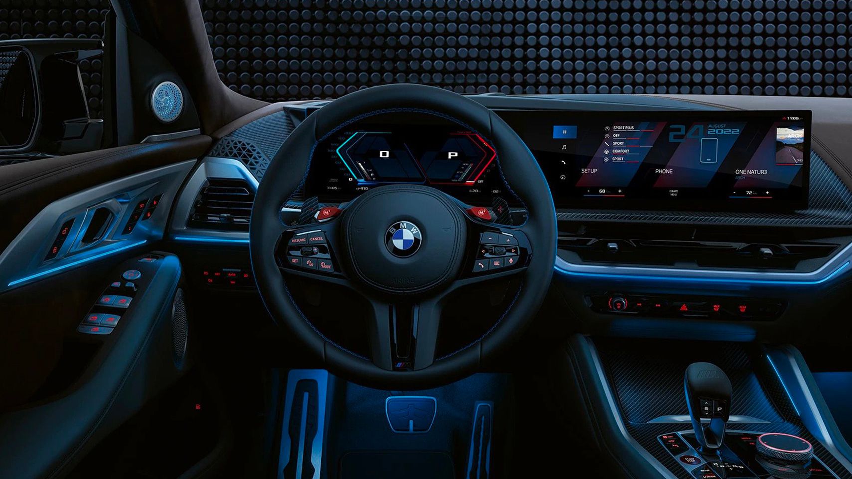 Driver’s perspective of the BMW XM interior featuring the M-specific steering wheel and blue ambient lighting.
