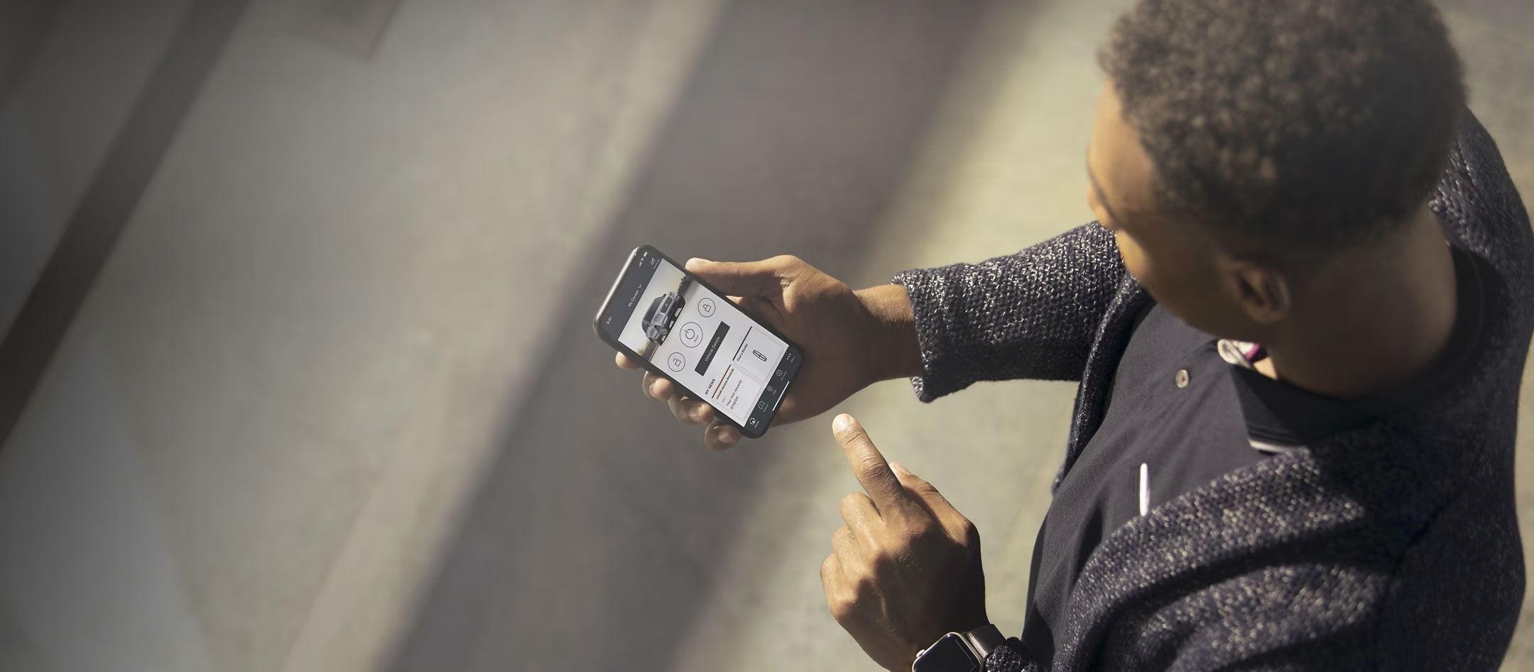 Man using the Lincoln Way app on his smartphone to access vehicle controls