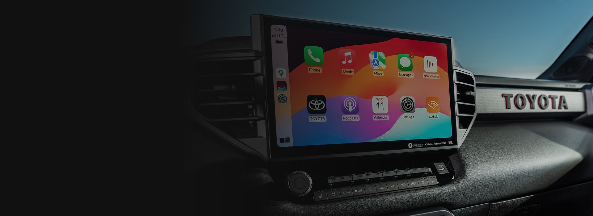 Le système d'infodivertissement Toyota utilisant Apple CarPlay avec plusieurs applications visibles sur le tableau de bord.