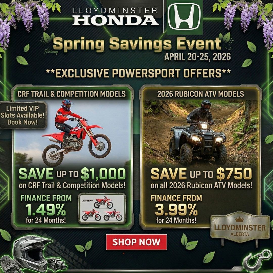 Smiling car salesman in a suit, holding a tablet in a dealership showroom.