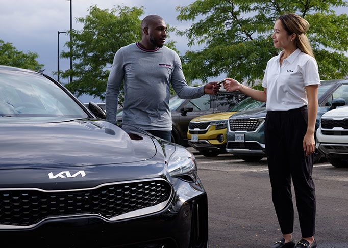 View from inside a car's driver's seat while driving through a tunnel at night, showing light trails.