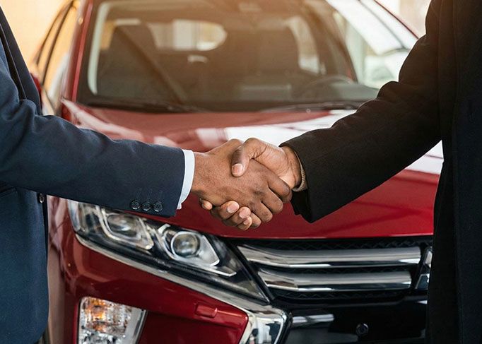 View from inside a car's driver's seat while driving through a tunnel at night, showing light trails.