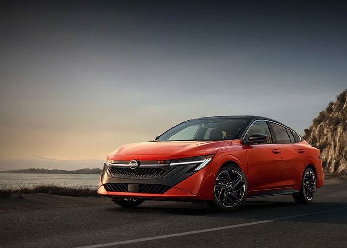 View from inside a car's driver's seat while driving through a tunnel at night, showing light trails.