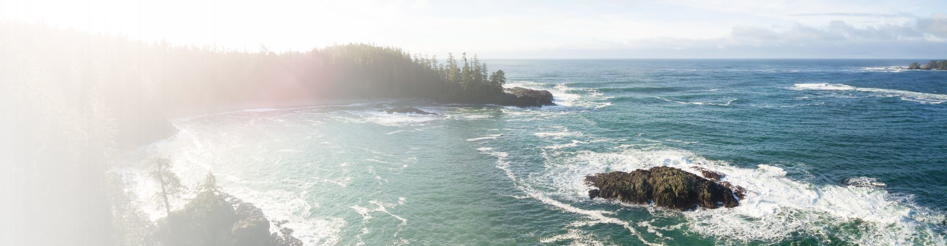 A white sedan speeds down a road, with blue motion blur effects.