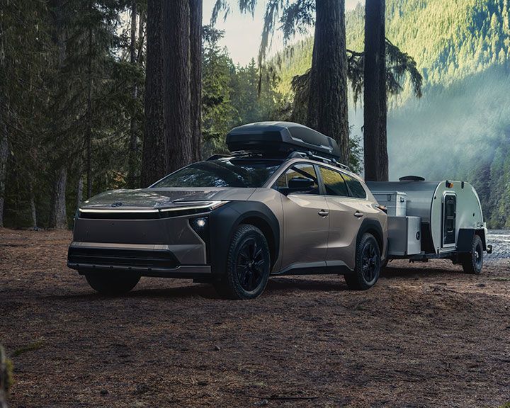 Overhead view of many cars in various colors, parked in three organized rows on a white background.