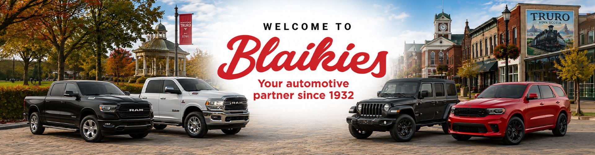 Lineup of RAM, Jeep, and Dodge vehicles parked on a town square in front of the Blaikies welcome banner.